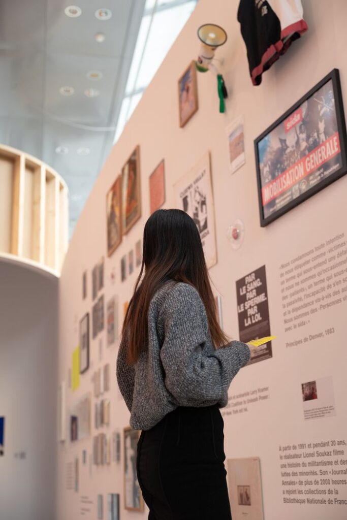 The Art of Drawing Readers In: Your attractive post title goes here A woman stands captivated by artwork in a modern museum exhibition.
